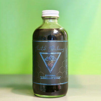 Elevated Elderry Syrup in a clear bottle with a black and blue label.